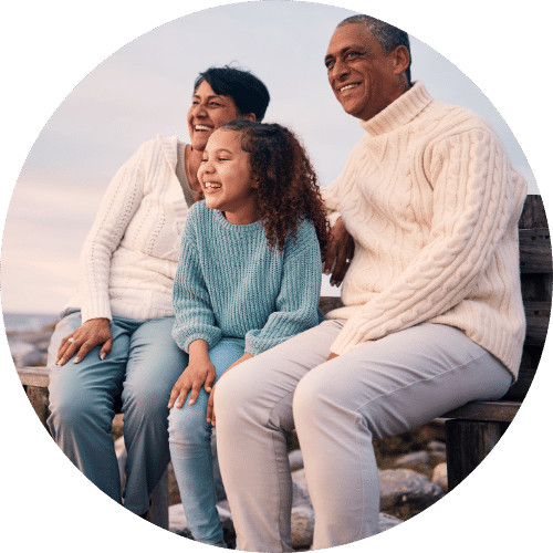 Family smiling on the beach