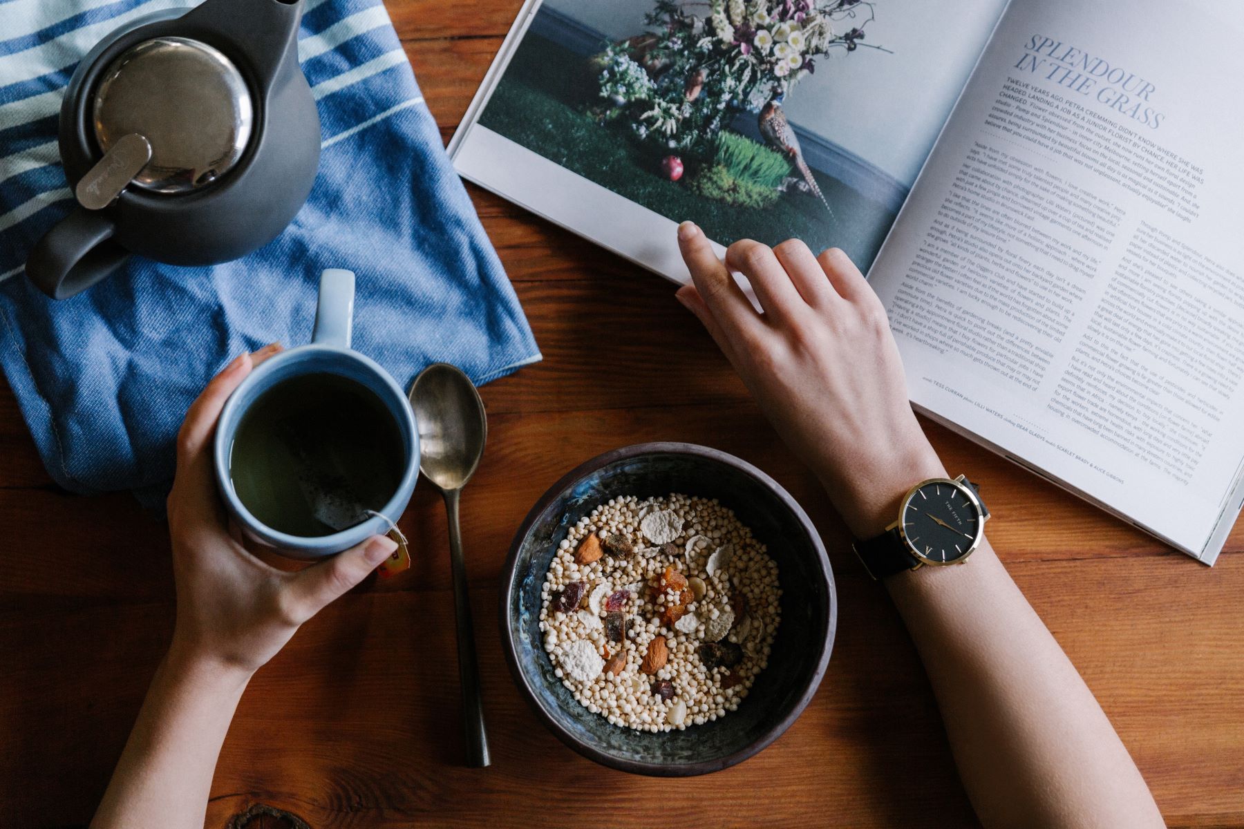 drinking coffee with breakfast while looking at a magazine